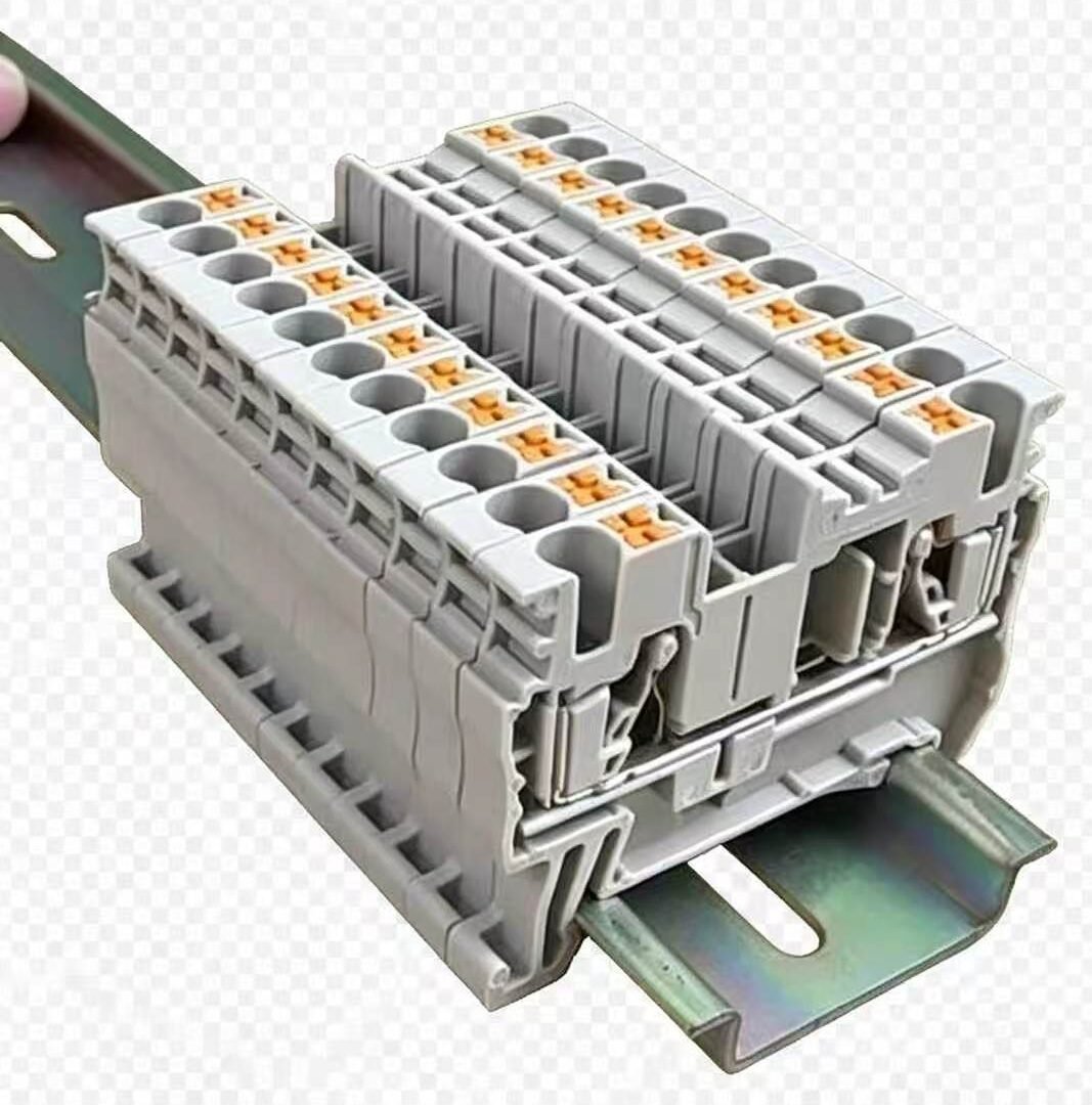 DIN rail spring-cage terminal blocks with orange push-in levers mounted on steel DIN rail
